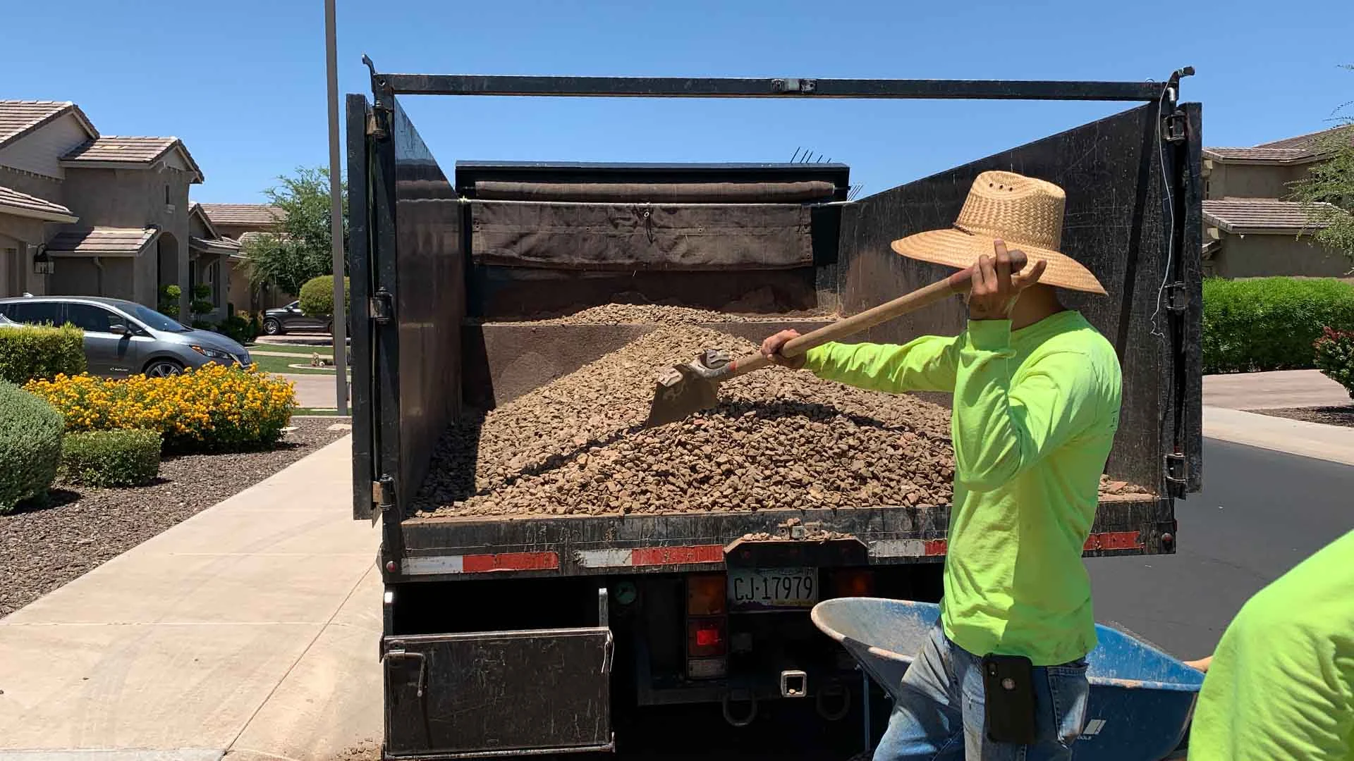 Landscape worker preparing rocks for installation at a home in Gilbert, AZ.