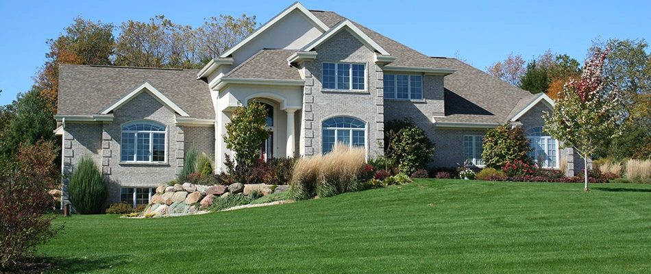 A well maintained lawn in front of a grey home in Gilbert, AZ.
