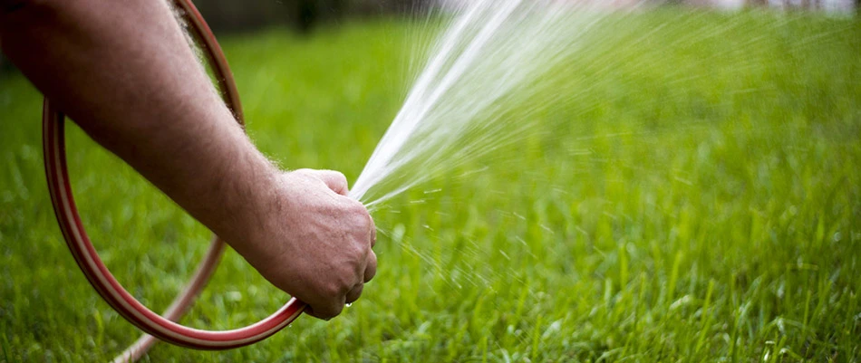 Our client hand watering his lawn in Gilbert, AZ.