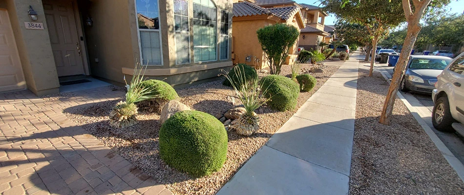 Landscape beds covered with rock in front of a home in Mesa, AZ.