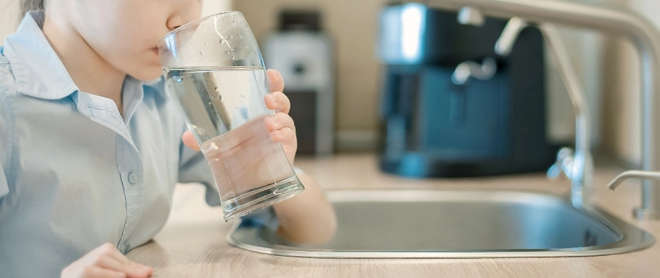 Child drinking a glass of water that may be at risk in Chandler, AZ.