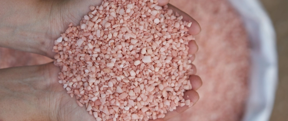 Handful of potassium pellets that is in fertilizer treatments in Mesa, AZ.