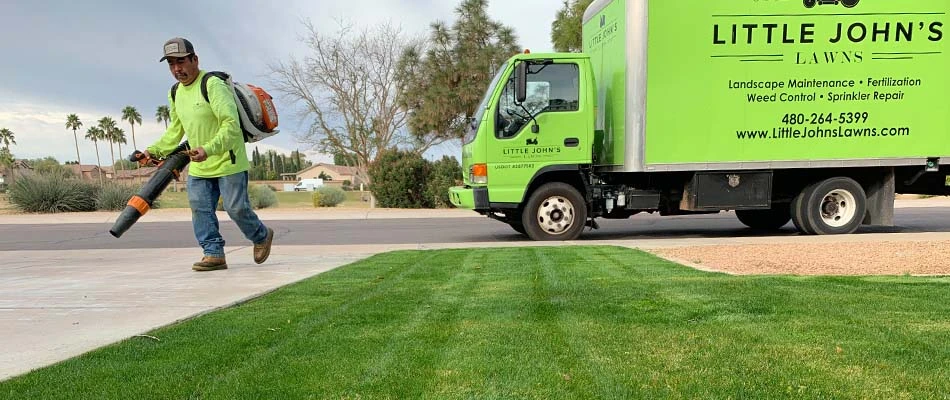 Lawn care worker with a leaf blower in Gilbert, AZ.