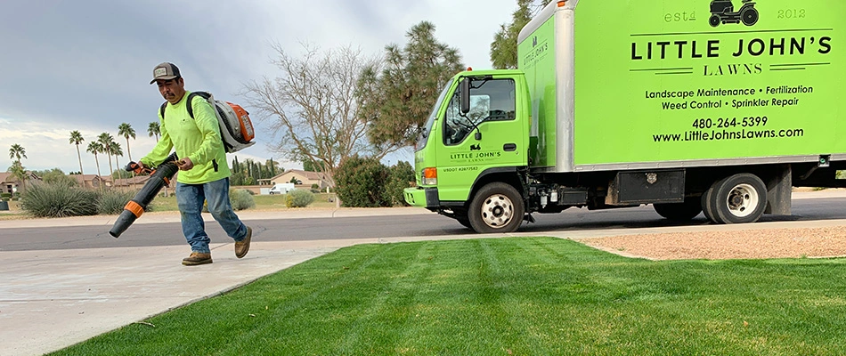 Professional blowing debris away from lawn in Gilbert, AZ.