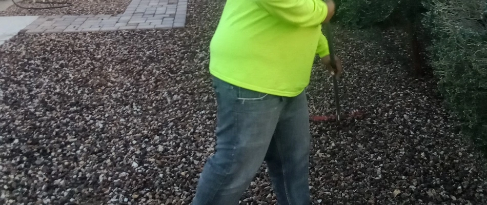 Professional raking granite on property in Mesa, AZ.